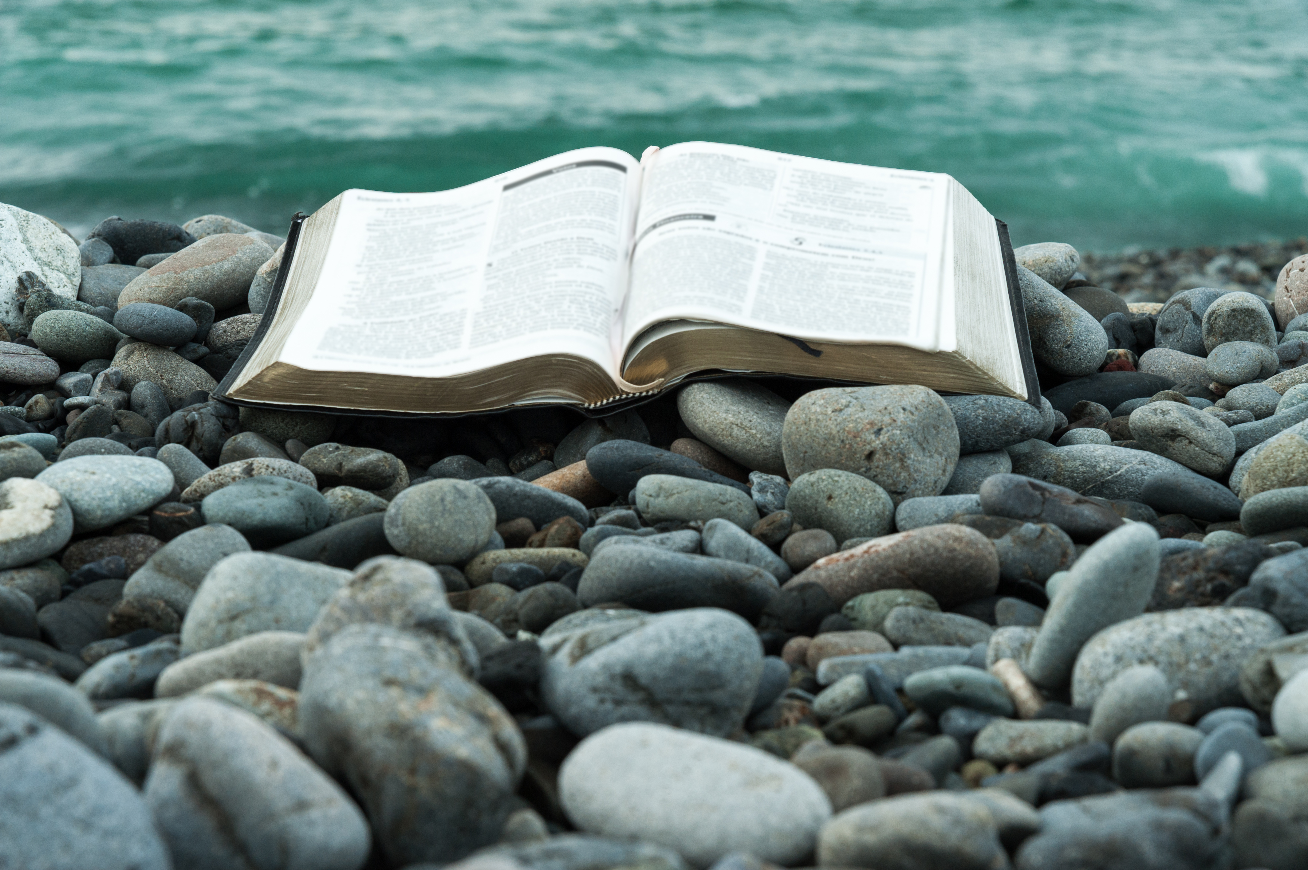 bible on a rocky beach